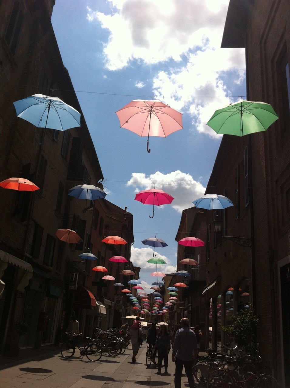 Umbrellas in the sky in an alley in Italy